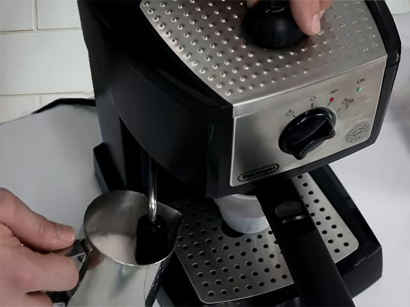 Top down view of the DeLonghi EC155 frothing milk