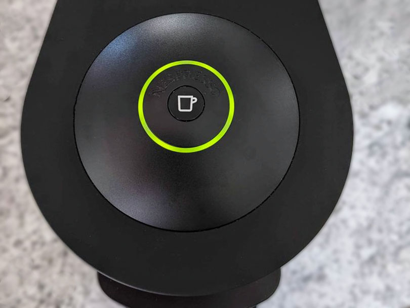 Close up of the 'make coffee' button on the Nespresso Vertuo Plus