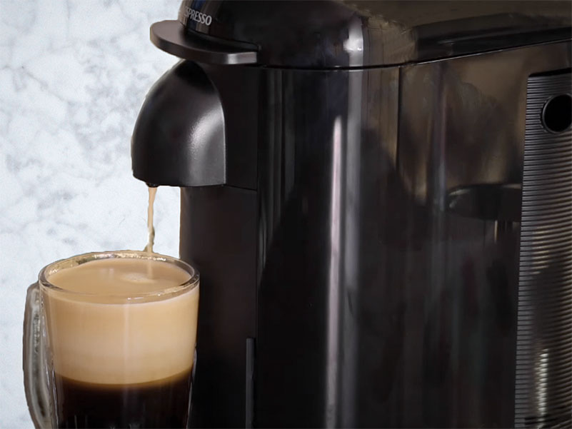 Cup of coffee being freshly made by the Nespresso Vertuo Plus