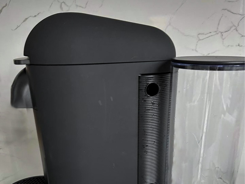 Side view of the Nespresso Vertuo Plus and water tank