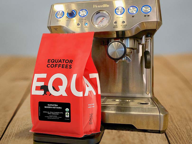 Bag of Sumatra Queen Ketiara coffee beans from Equator Coffees in front of Breville espresso machine