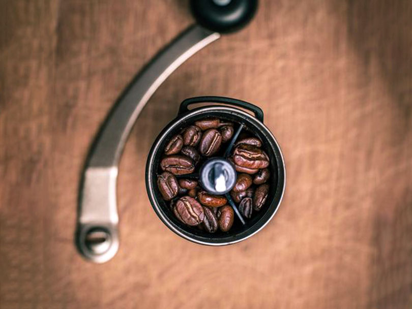 Top down view of the Polex Mini II - the lid is removed so you can see that it's filled with coffee beans