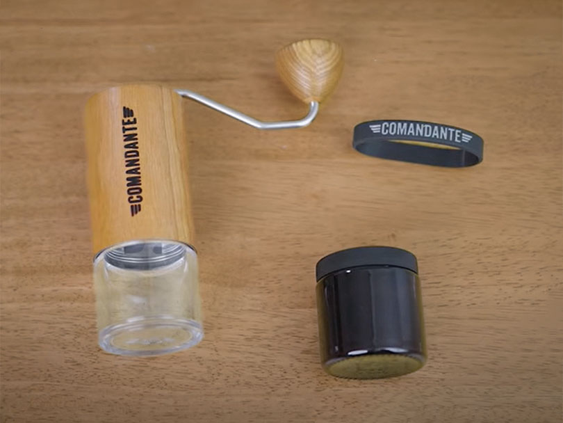 Comandante C40 MK4 (American Cherry) lying flat with spare catch cup, lid, and rubber sleeve