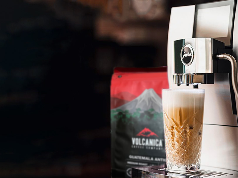 Jura Z10 with a latte on the drip tray and Volcanica coffee beans behind