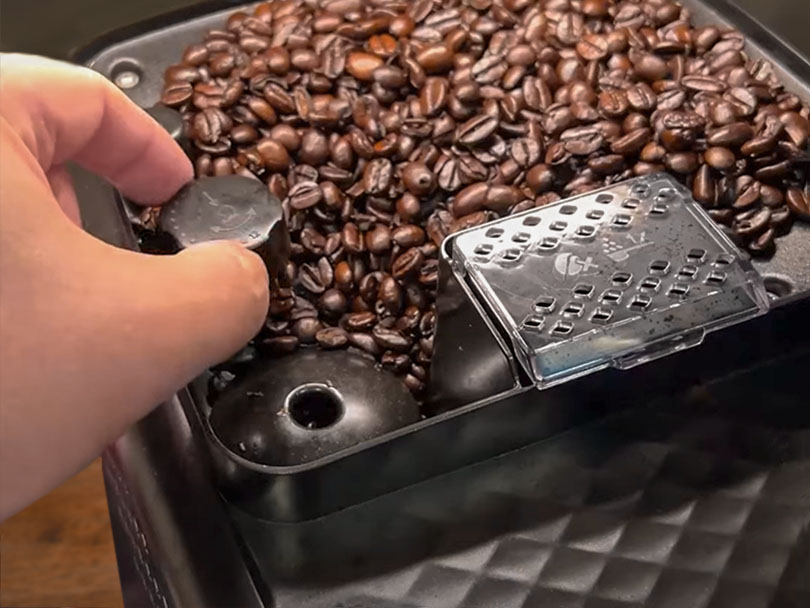 Hand adjusting the grind settings on the Philips 3200 LatteGo