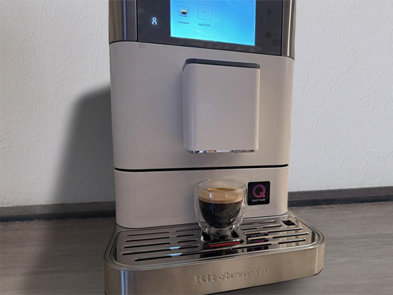 A shot of freshly made espresso sitting on the drip tray of the KitchenAid KF8