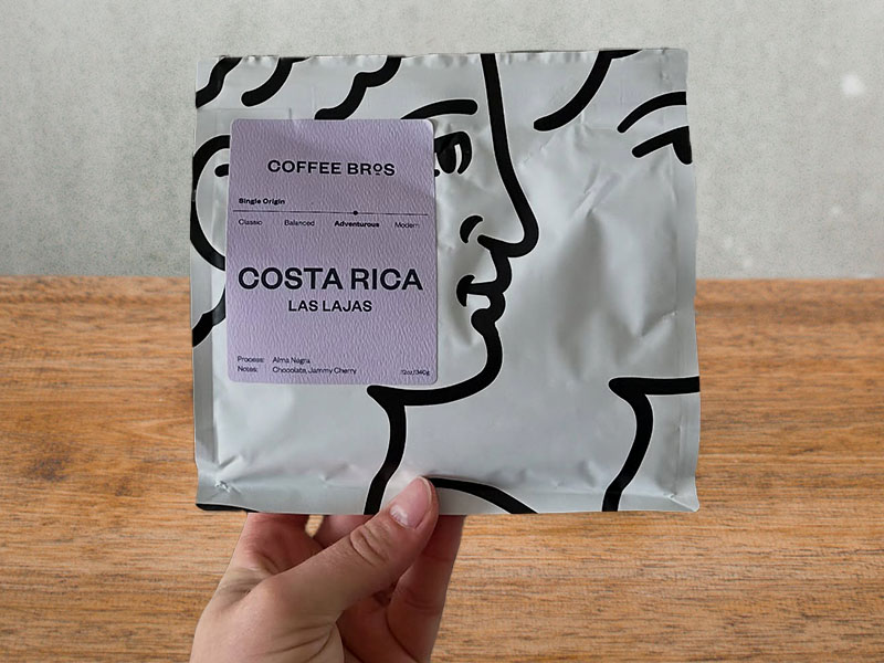 Hand holding a bag of Coffee Bros, Costa Rica Las Lajas beans