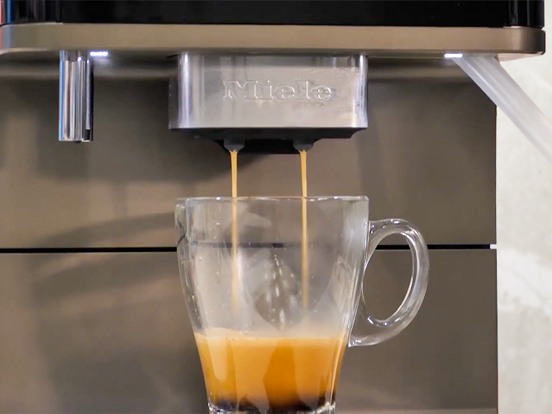 A shot of espersso being dispensed on the Miele CM 6360