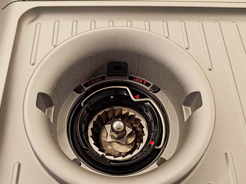 Top-down view of the Breville Barista Express Impress grinder with the bean hopper removed