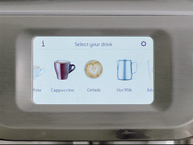 Breville Barista Touch screen prompting the user to 'select your drink'. Cappuccino, hot milk, and custom drink named 'cortado' are shown